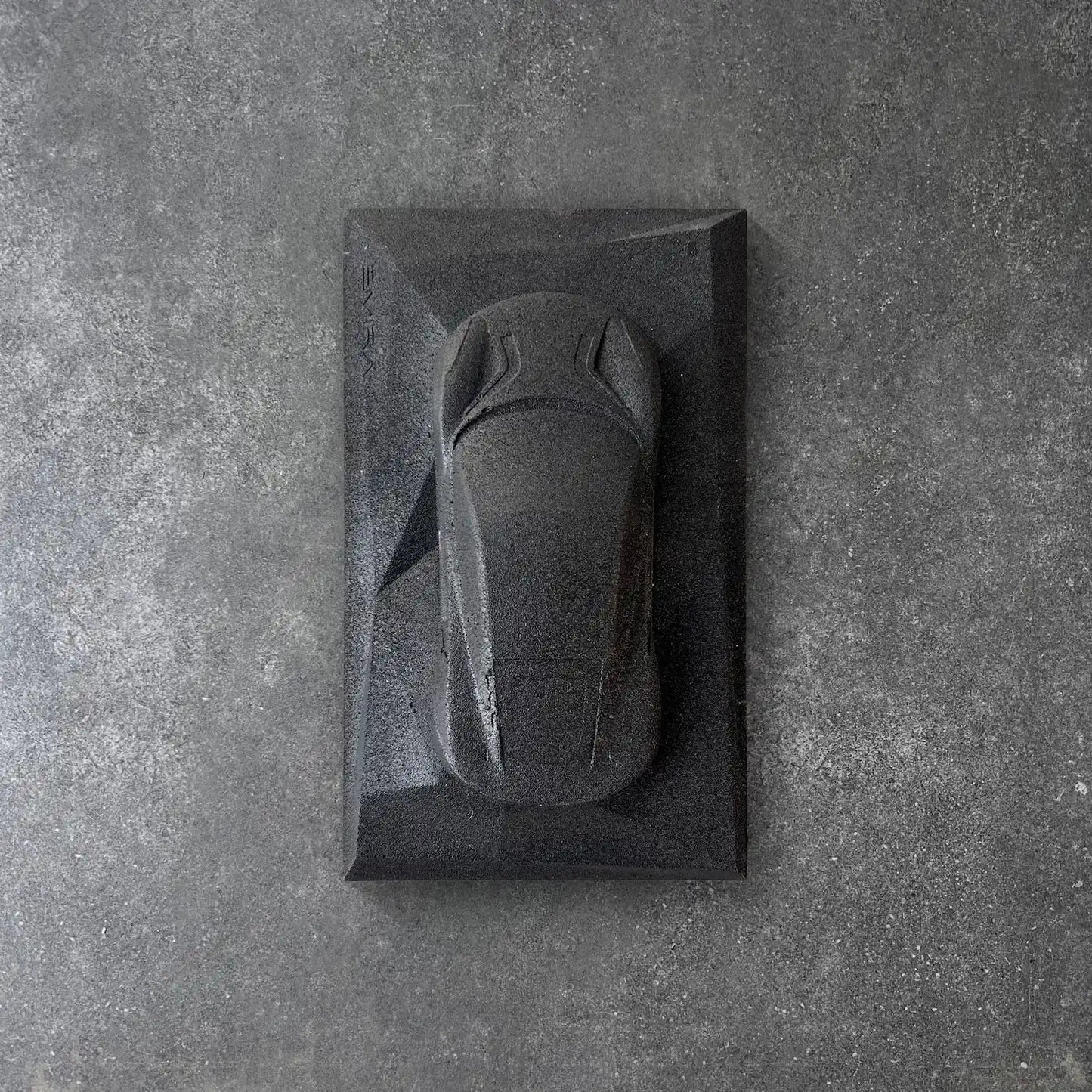 Lotus Emira concrete sculpture in deep black raw stone minimal finish by CarArt Dubai