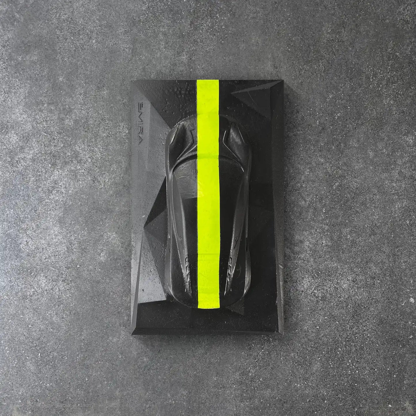 Concrete Lotus Emira sculpture in black with neon yellow racing stripe – CarArt Dubai