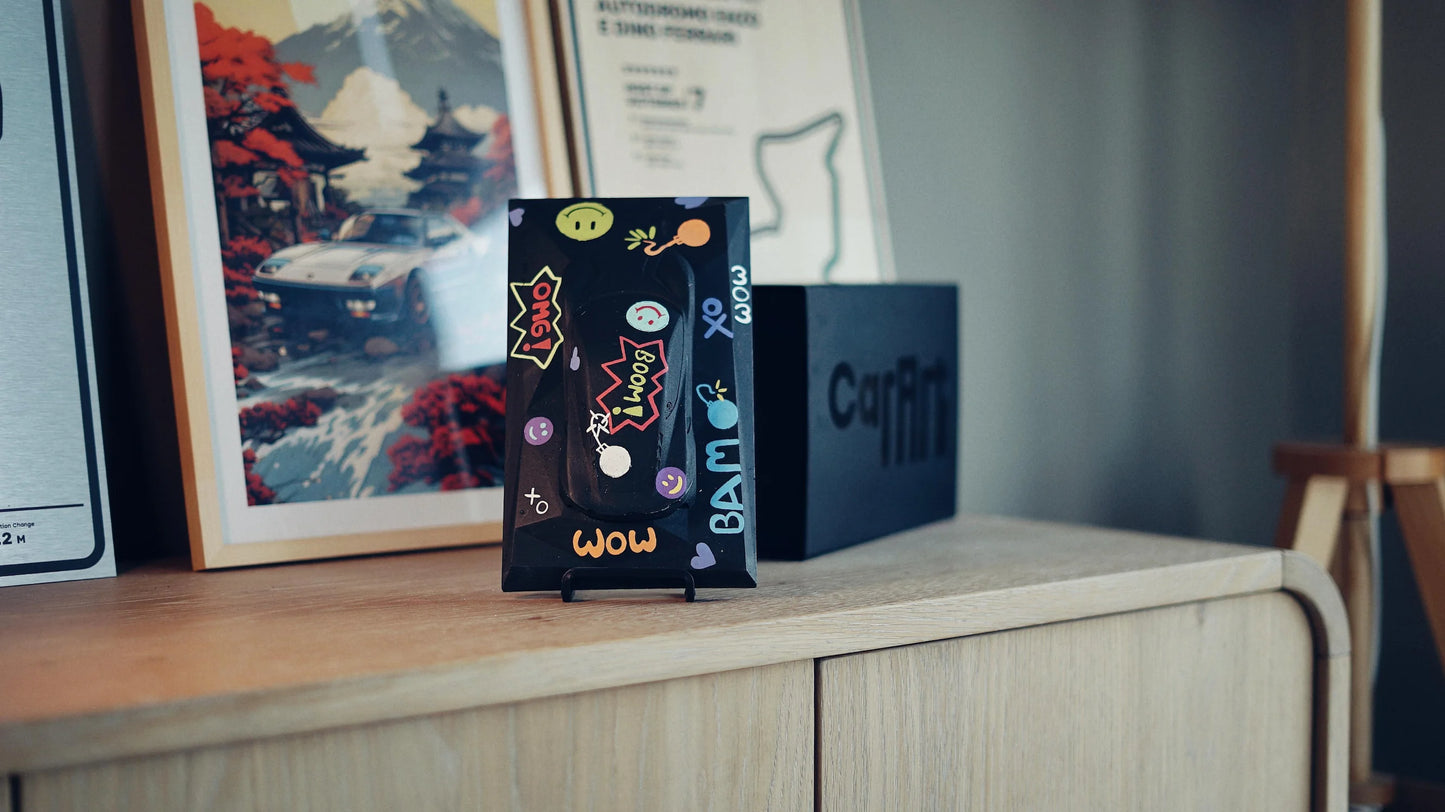 Lotus Emira concrete sculpture art mockup in black pop art graffiti style with comic lettering and emojis, portrait display by CarArt Dubai