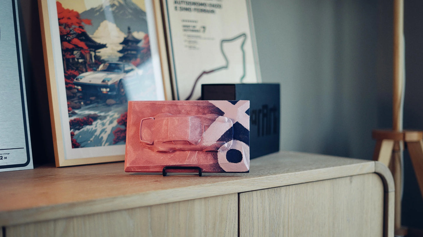 Porsche 930 concrete sculpture mockup in pink finish with XO graffiti street art design, landscape display by CarArt Dubai