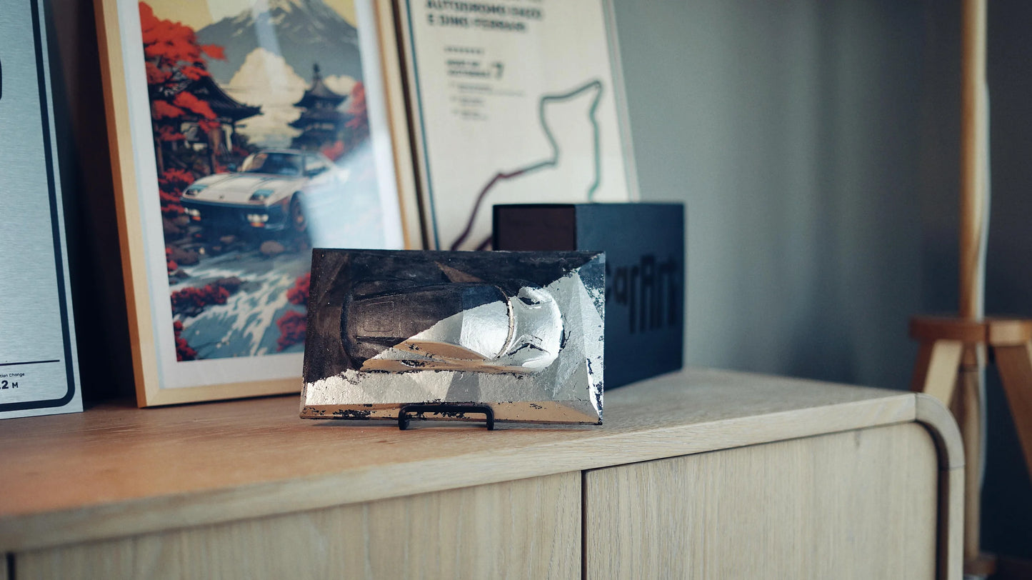 Lotus Emira concrete sculpture mockup in silver-black industrial metallic finish, landscape display by CarArt Dubai