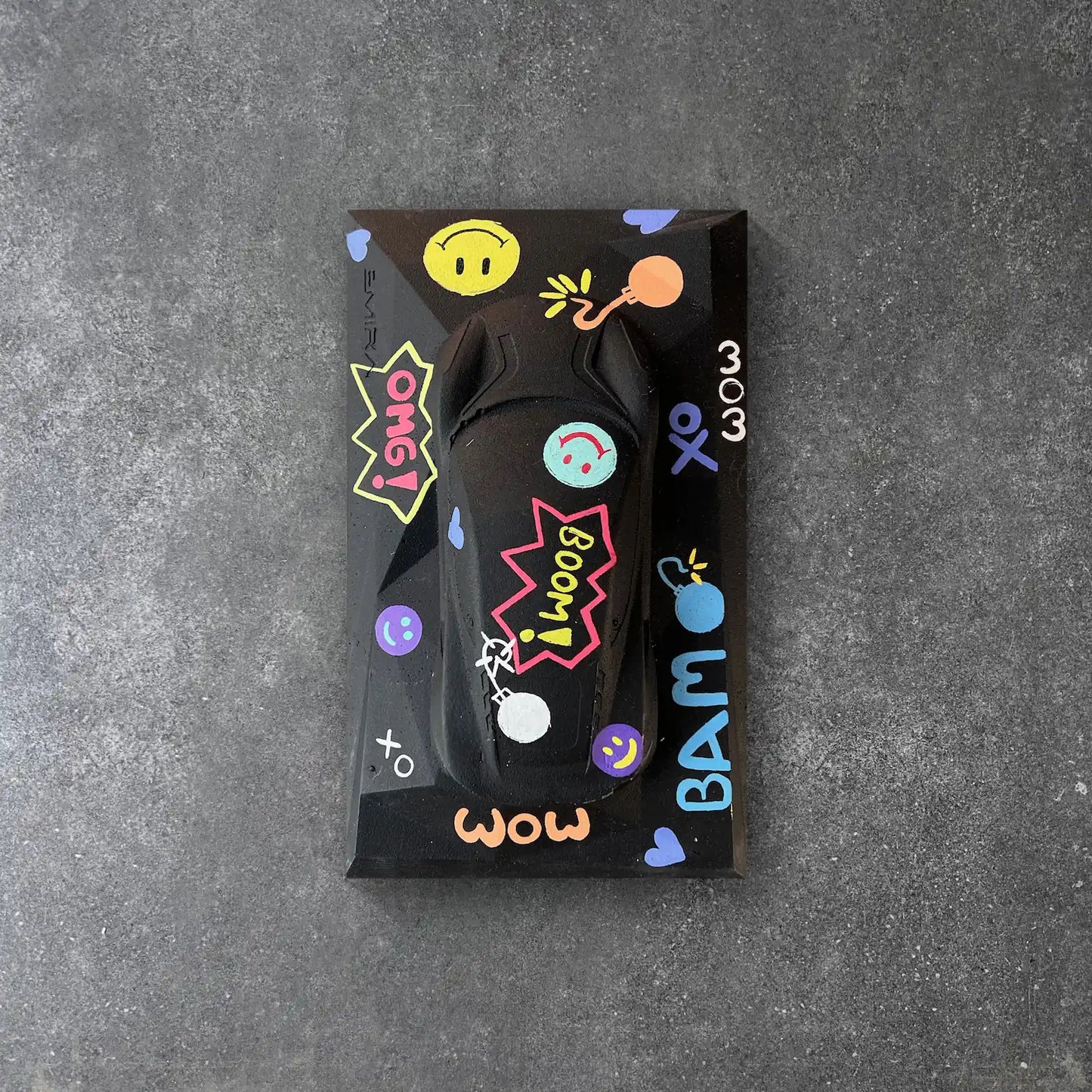 Lotus Emira concrete sculpture art in black pop art graffiti style with comic lettering and emojis by CarArt Dubai
