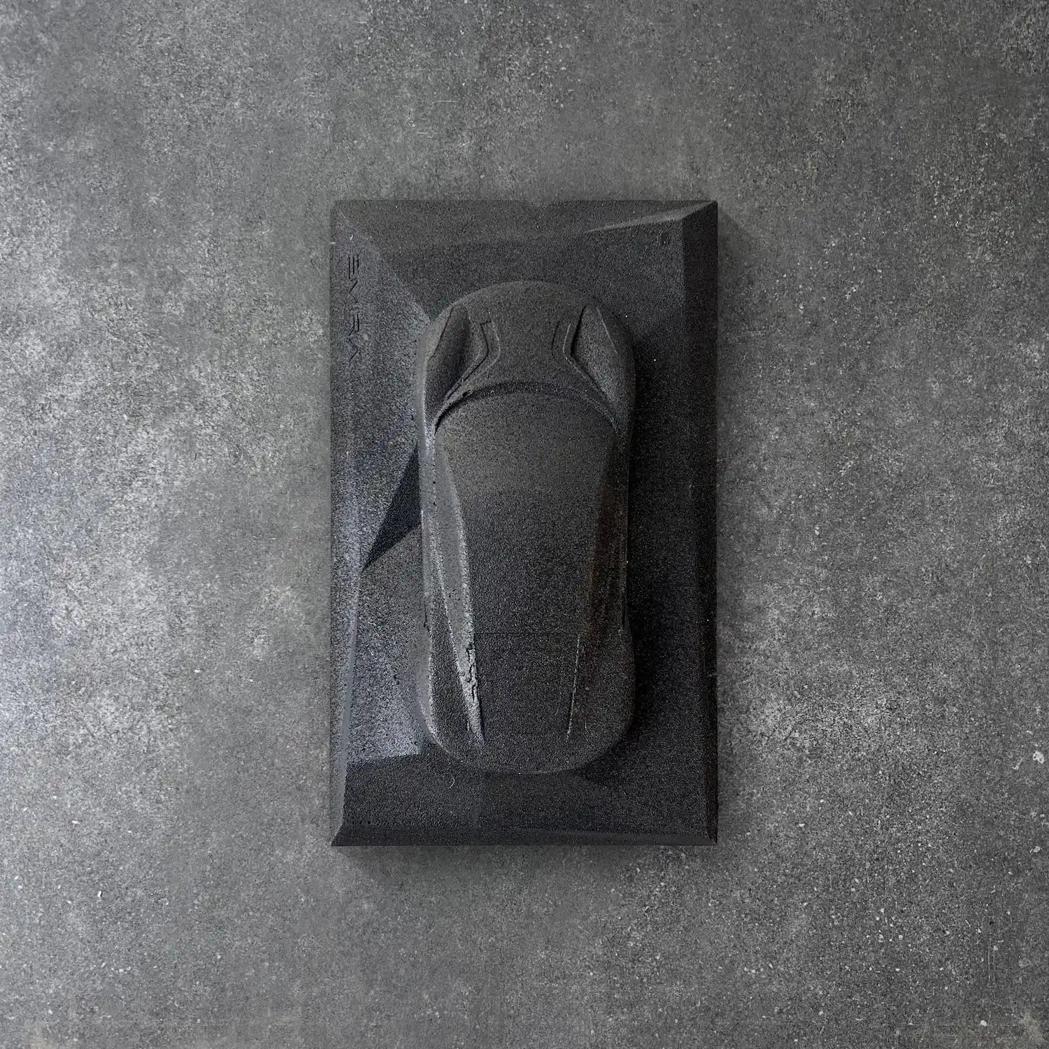 Lotus Emira concrete sculpture in deep black raw stone minimal finish by CarArt Dubai