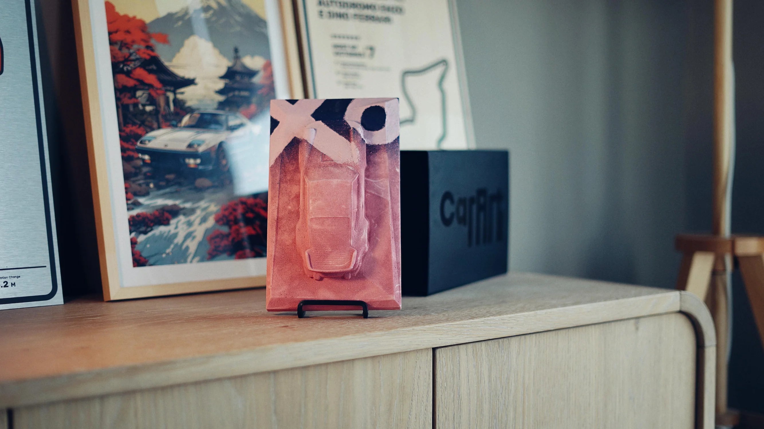 Porsche 930 concrete sculpture mockup in pink finish with XO graffiti street art design, portrait display by CarArt Dubai